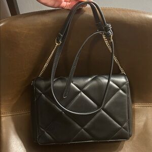 Crossbody black purse 7x10 with adjustable strap.